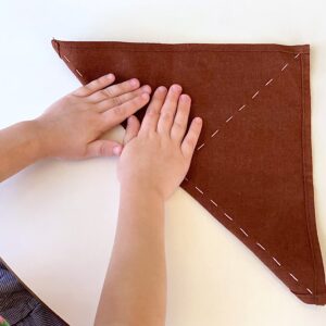 Teach Your Child Responsibility and Boost Confidence with this Simple Daily Task: Folding Napkins and Clothes