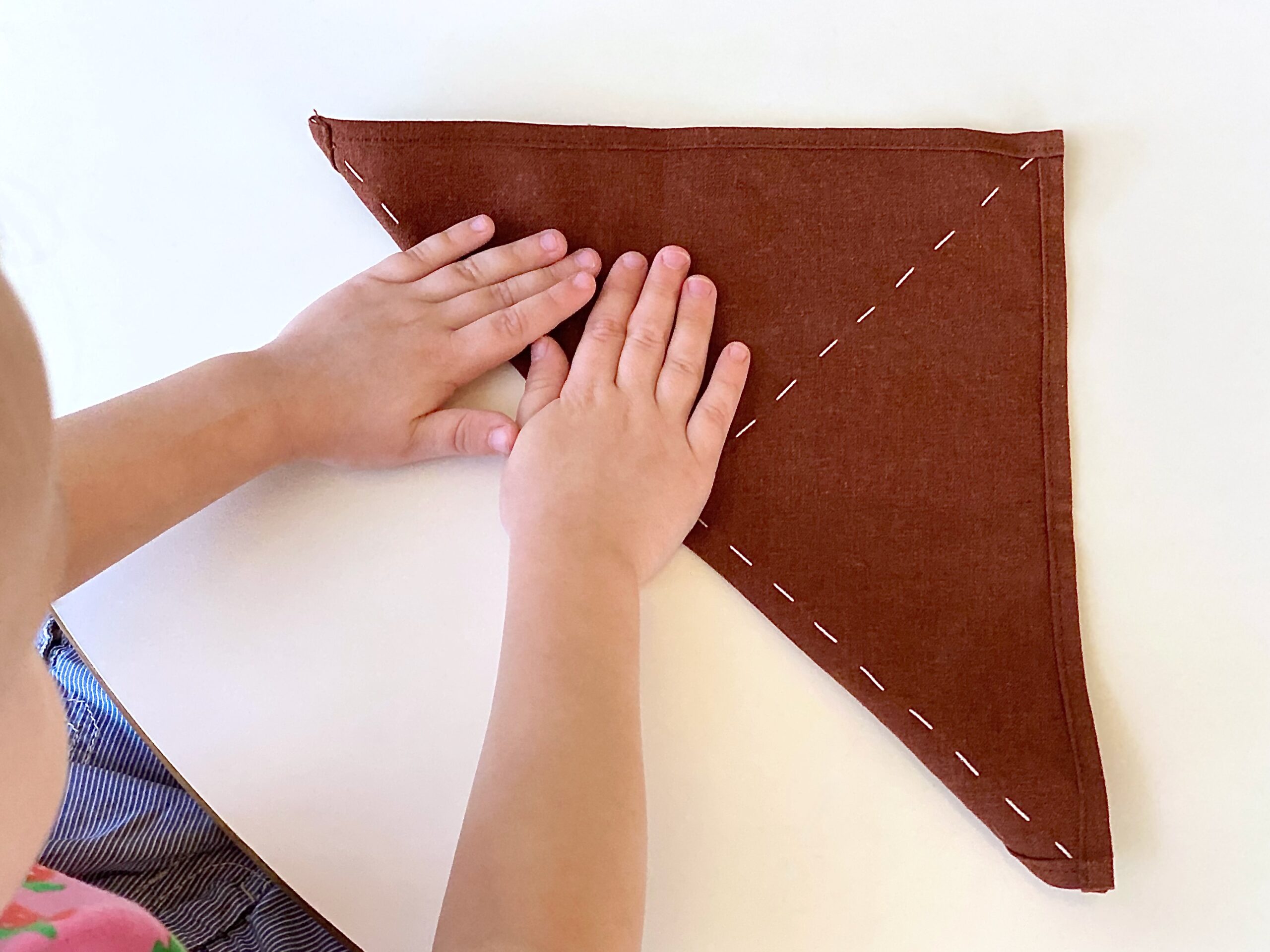 Teach Your Child Responsibility and Boost Confidence with this Simple Daily Task: Folding Napkins and Clothes